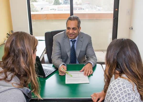 Vic at desk with clients